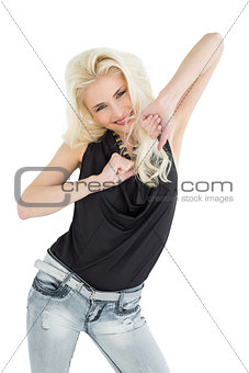 Portrait of a happy young casual woman dancing