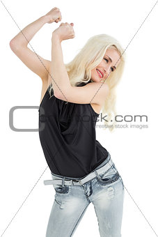 Happy young casual woman dancing