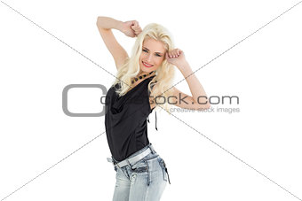 Happy young casual woman dancing