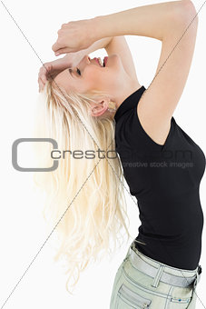 Side view of a cheerful beautiful casual blond