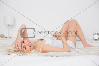 Portrait of a pretty woman resting in bed