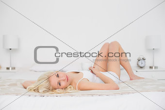 Portrait of a pretty woman resting in bed