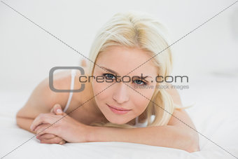 Close up portrait of a beautiful blond lying in bed