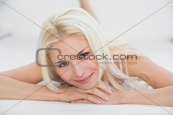 Close up of a smiling beautiful blond in bed