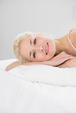 Close up portrait of pretty woman resting in bed