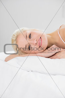 Close up portrait of pretty woman resting in bed