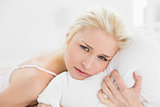 Close up of a pretty young woman resting in bed