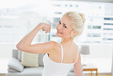 Rear view portrait of fit woman flexing muscles