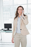 Elegant businesswoman using mobile phone in office