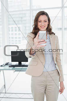 Elegant businesswoman text messaging in office