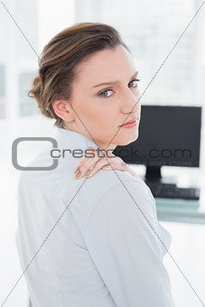 Portrait of businesswoman with neck pain in office