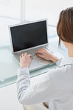 Close up rear view of businesswoman using laptop in office