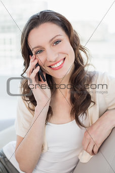 Portrait of relaxed woman using cellphone on sofa