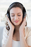 Close up of relaxed casual woman enjoying music