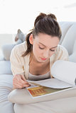 Relaxed casual woman reading a book on sofa