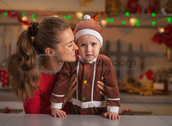 Portrait of mother and baby in christmas decorated kitchen