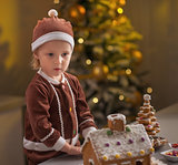 Portrait of baby with christmas cookie house