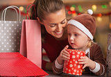 Happy mother and baby among christmas shopping bags