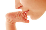 mother kiss foot her newborn baby 