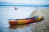 Kayak on the Sea Shore with Kayakers in the Background