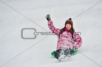 girl sliding in the snow