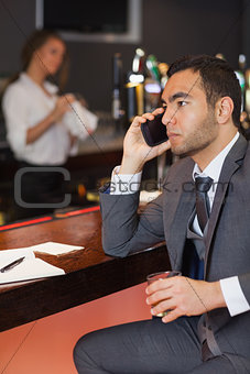 Serious businessman having a phone call