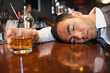 Drunk and unconscious businessman lying on a counter