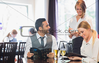 Business people reading menu and ordering
