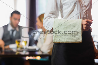 Waitress standing in front of two business people talking