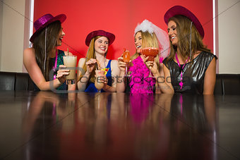 Attractive friends at a hen night drinking cocktails