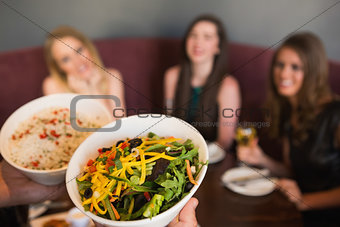 Waiter bringing the salad