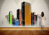 Businesswoman painting colorful city on wall