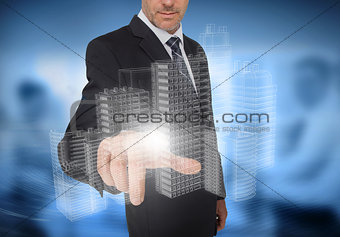 Businessman touching holographic faint city