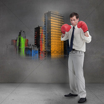 Businessman with boxing gloves standing in front of grey wall