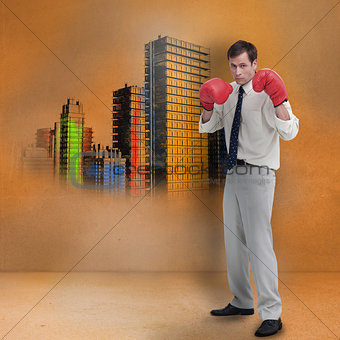 Businessman with boxing gloves standing in front of colored city