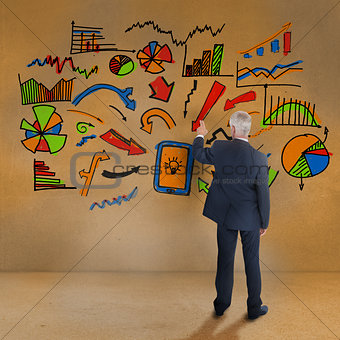 Rear view of mature businessman pointing at illustrations