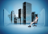 Businessman on swivel chair looking at holographic city
