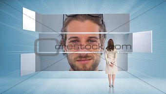 Rear view of businesswoman looking at content man