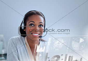 Cheerful woman with headset using futuristic interface hologram