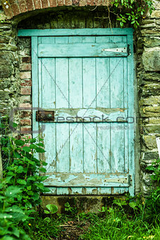 Blue wooden door in a stone wall