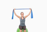 Pretty woman training sitting on fitness ball
