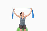 Cheerful woman training with a resistance band