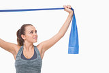 Ponytailed young woman training using a resistance band