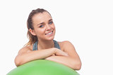 Sweet young woman supporting herself with a fitness ball