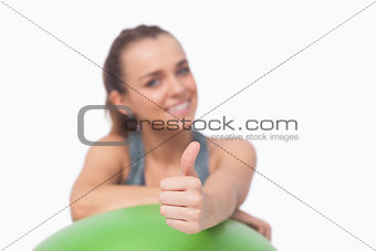 Ponytailed woman showing thumbs up