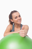 Cheerful sporty woman showing thumbs up