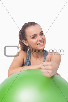 Cheerful sporty woman showing thumbs up