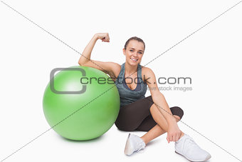Young woman showing her arm muscles