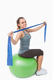 Attractive young woman sitting on therapy ball