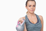 Young woman training her arms with a kettle bell